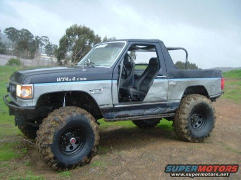 1994 Ford Bronco - This modified Ford Bronco features oversized tires and a lifted suspension, with its doors removed.
