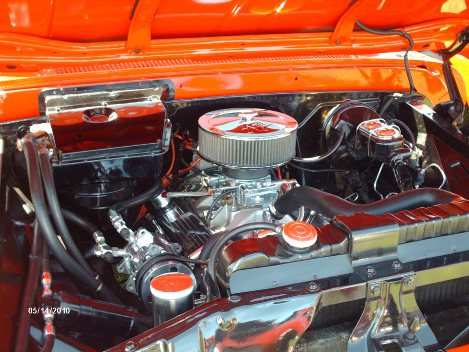 Engine bay with chrome air cleaner and orange painted firewall