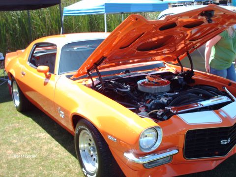 1992 Ford Bronco - This orange muscle car, likely a 1970s model, is displayed with its hood open at an outdoor event.