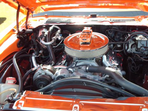 1992 Ford Bronco - The engine bay is bright orange, with a miniature truck placed on top of the air filter assembly.
