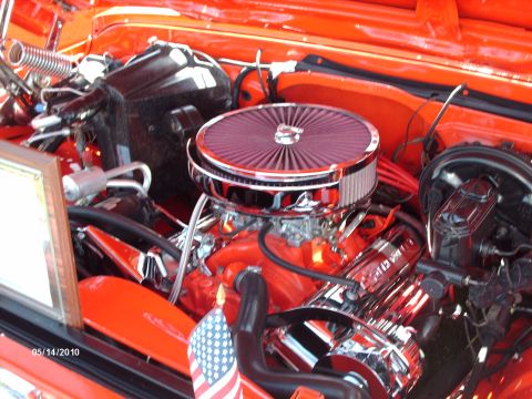 1992 Ford Bronco - Close-up of a modified V8 engine bay with chrome accents and an American flag detail.
