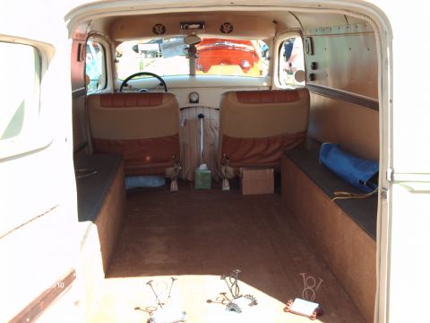 1992 Ford Bronco - The spacious interior of a van, showing bench seating and ample cargo room, with another vehicle visible outside.