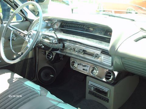 1992 Ford Bronco - The dashboard of a classic car features a large speedometer and vintage radio controls.