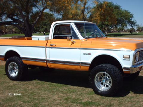 1992 Ford Bronco - This lifted 1971 Chevrolet C10 pickup features a distinctive two-tone orange and white paint scheme.