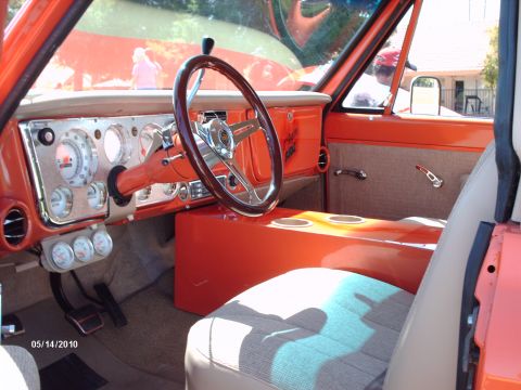 1992 Ford Bronco - Interior view of a customized truck, aftermarket gauges and a wood-rimmed steering wheel.