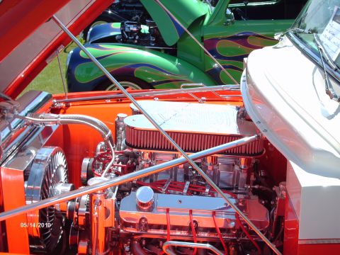 1992 Ford Bronco - Custom engine bay with polished chrome parts and a prominent air filter, with other show cars visible in the background.