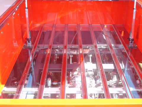 1992 Ford Bronco - The interior of a custom truck bed features clear panels revealing the mechanical components below.
