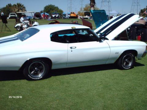 White 1970s muscle car with black racing stripes and SS badging