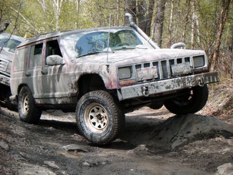 1998 Jeep Cherokee - This heavily modified 1998 Jeep Cherokee navigates a challenging off-road obstacle, its capabilities.