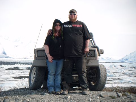 1998 Jeep Cherokee - Couple poses with their modified 1998 Jeep Cherokee in a winter landscape.
