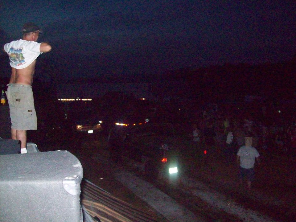 Night scene with crowd and distant vehicles