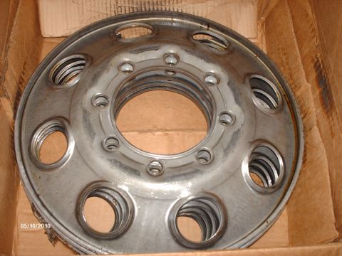 1982 Ford F-100 - A stack of metal wheel covers is shown inside a cardboard box, with a date stamp visible.