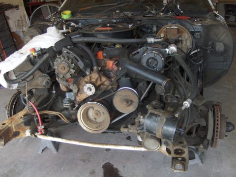 1971 Chevrolet Camaro - The engine bay of a vehicle is shown with the V8 engine and front suspension components exposed.