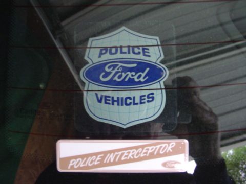 2003 Ford Crown Victoria - Decals on the rear window indicate the vehicle is a Ford Police Interceptor.