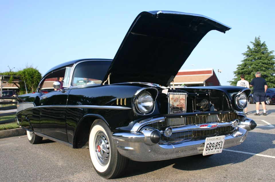 Black 1957 Chevrolet Bel Air with hood open, front view