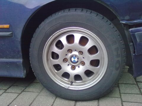 1998 BMW 3 Series - A close-up view of a BMW wheel and tire, showing the brand's iconic logo on the hubcap.