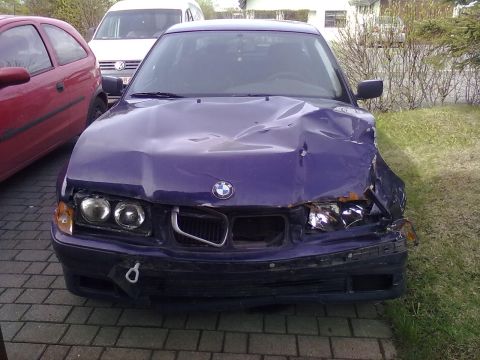 1998 BMW 3 Series - Frontal damage to a purple 1998 BMW 3 Series, parked next to other vehicles.