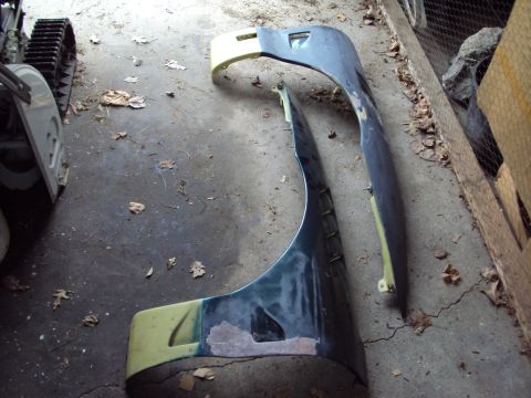 1993 Ford Probe - Two car fenders are on the floor, possibly for a Ford Probe GT.