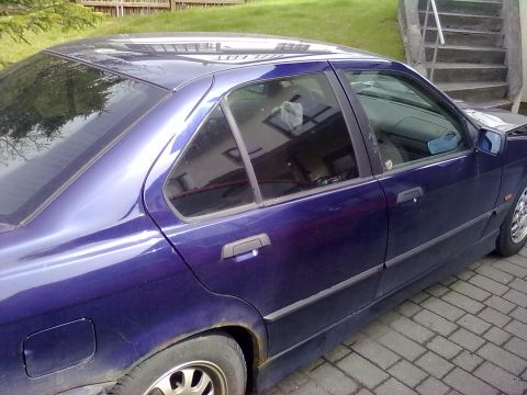1998 BMW 3 Series - A purple sedan is parked on a brick driveway, with stairs and a wooden fence in the background.