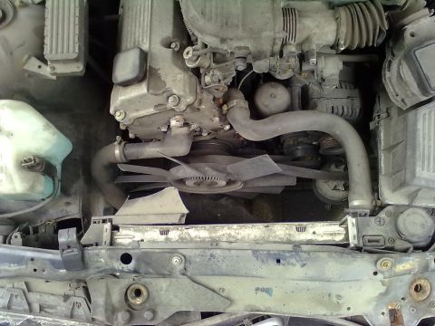 1998 BMW 3 Series - Close-up view of a BMW engine bay, showing the radiator fan and coolant hoses.
