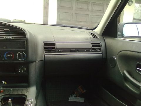1998 BMW 3 Series - The interior of a 1998 BMW 3 Series, the dashboard, air vents, and center console.