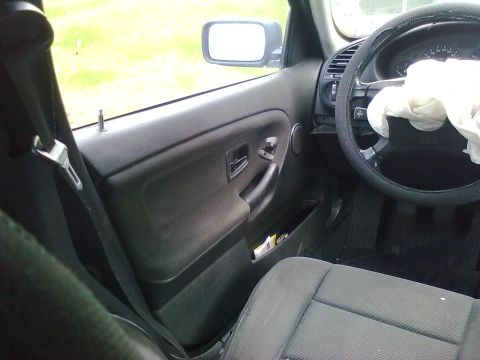 1998 BMW 3 Series - The interior of a 1998 BMW 3 Series shows damage to the steering wheel and deployed airbag.