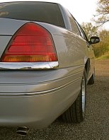 2000 Ford Crown Victoria - Rear view of a silver 2000 Ford Crown Victoria showing the taillight and chrome trim.
