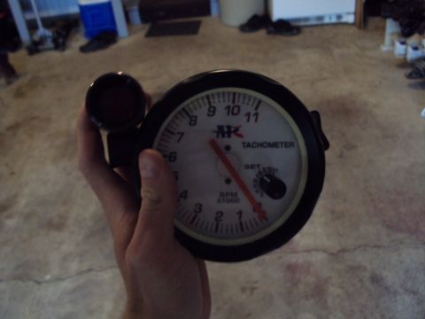 1993 Ford Probe - A tachometer gauge is held up for inspection, showing RPM readings.