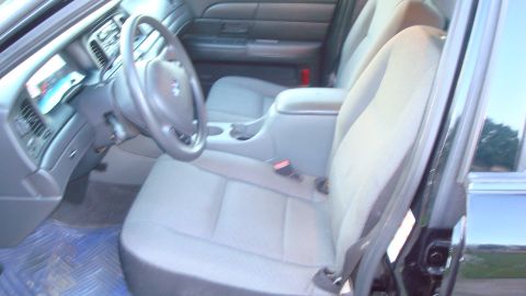 2004 Ford Crown Victoria - Interior view of a car's front seats and dashboard.