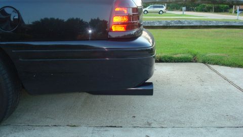 2004 Ford Crown Victoria - Rear view of a black 2004 Ford Crown Victoria, showing the bumper and a custom exhaust extension.