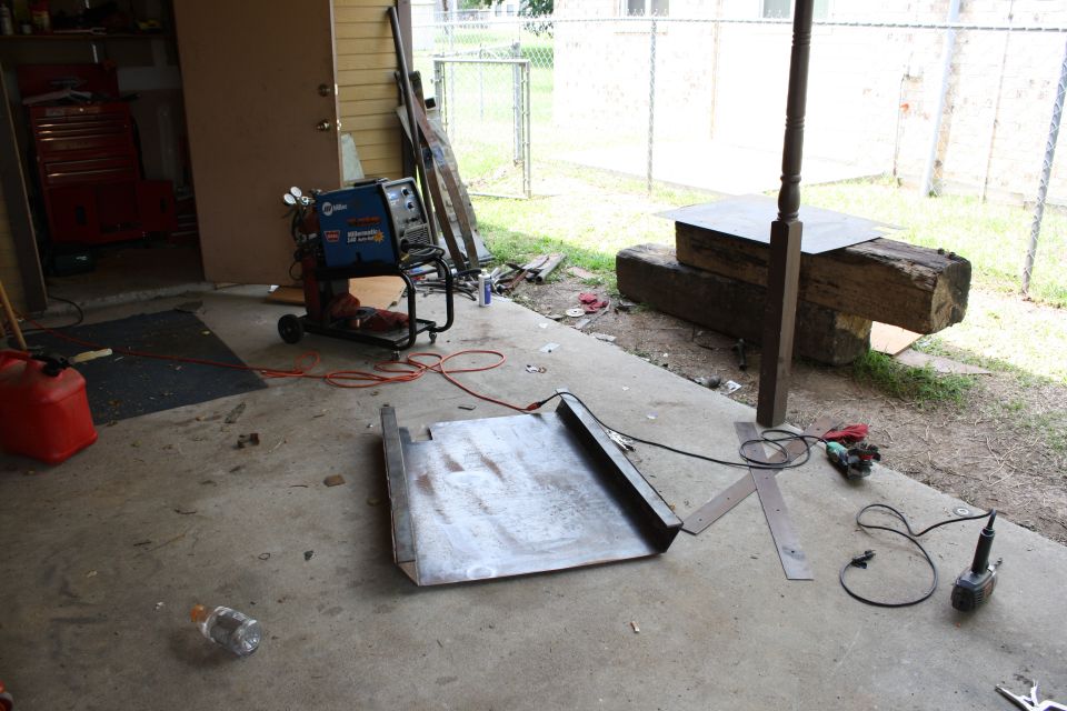 Metal sheet and welding equipment on a concrete patio