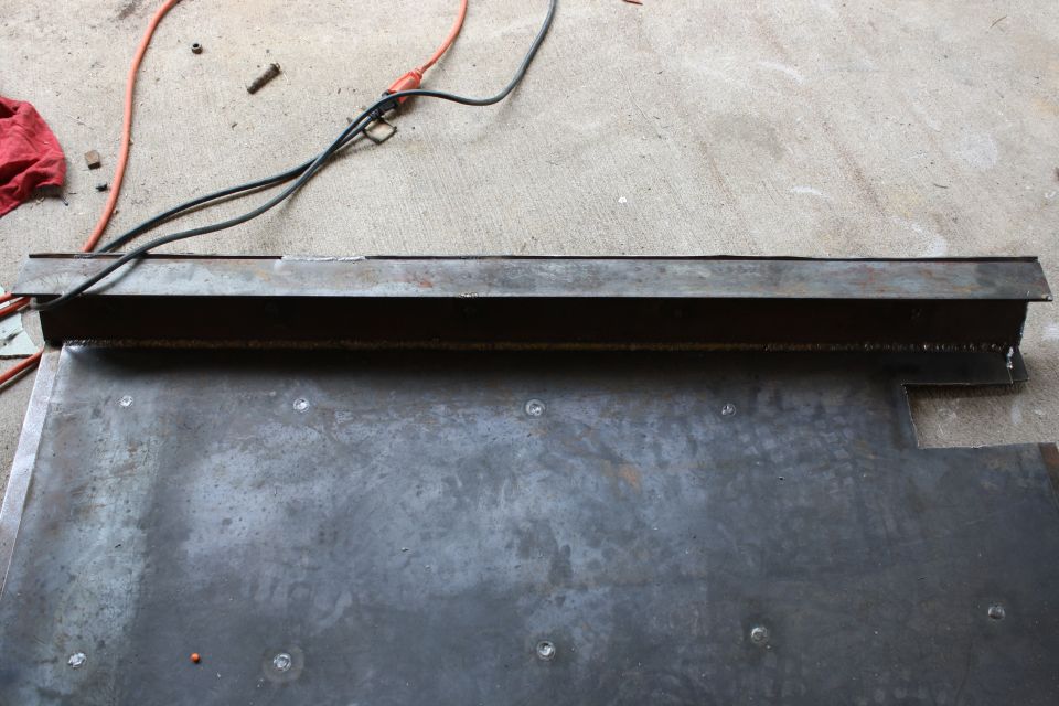 metal panel with wires and a red rag on concrete