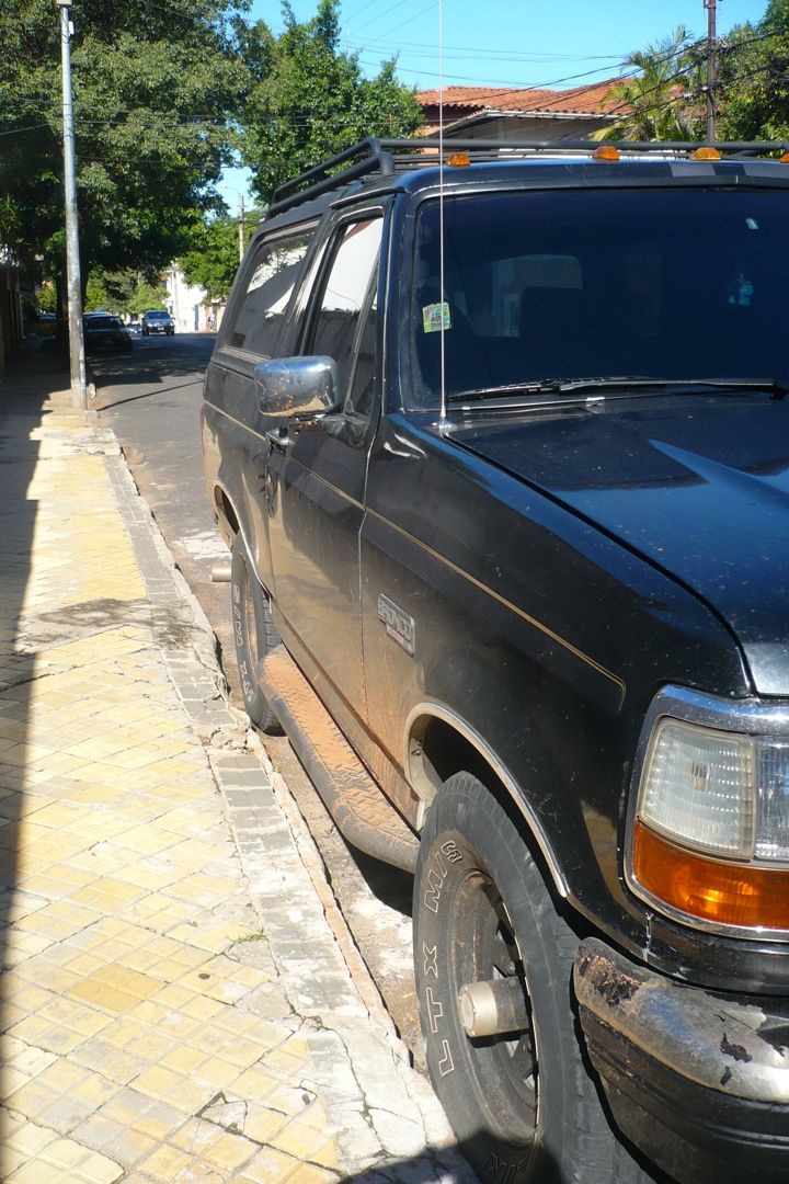 Black 1992 Ford Bronco parked on a street, side view