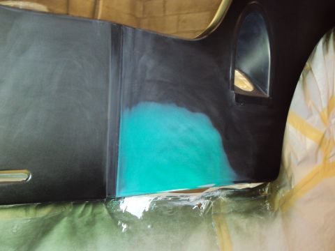1948 Jeep Wrangler - A car body panel is shown with a section of turquoise primer applied, indicating bodywork in progress.