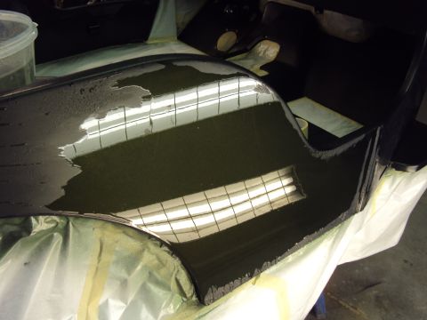 1948 Jeep Wrangler - Car part being worked on, covered in liquid and resting on drop cloths.
