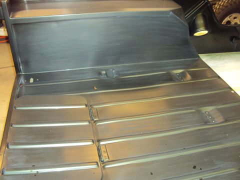 1948 Jeep Wrangler - The ribbed metal floor pan shows some wear and tear, with visible welds and mounting points.