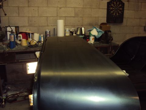 1948 Jeep Wrangler - Vehicle body in a garage, possibly undergoing repairs or restoration.