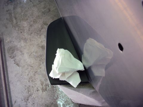 1948 Jeep Wrangler - Paper towels are placed on a dark trim piece attached to a car's door panel.