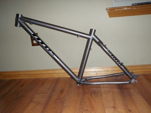 2001 Chevrolet Silverado 1500 - A gray bicycle frame is shown leaning against a wall indoors.