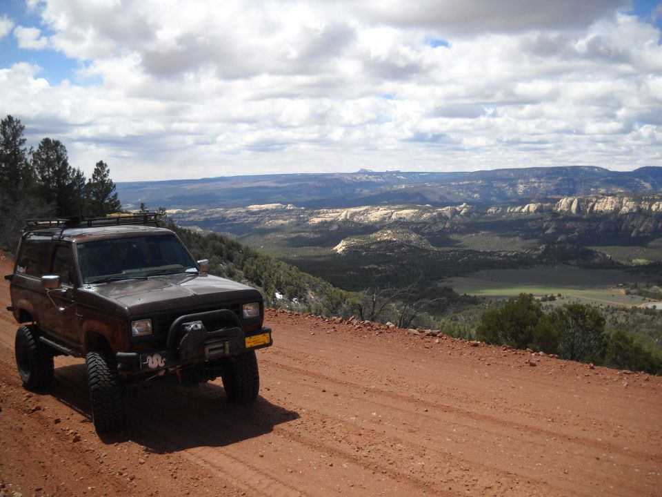 Brown 1986 Ford Bronco II on a dirt road overlooking a canyon