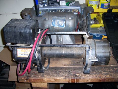 1991 Ford Bronco - A winch assembly a Baldor motor and a Chicago Electric motor is shown mounted on a wooden surface.