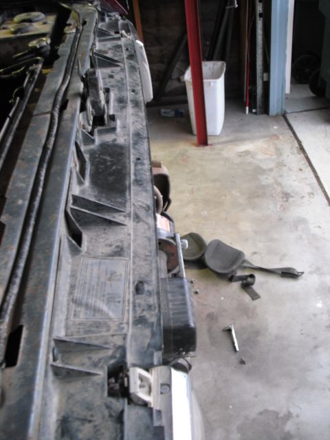 1991 Ford Bronco - Radiator support bracket, possibly from a Ford vehicle, with some text on the surface.
