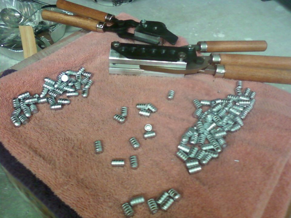 Bullet mold and cast bullets on a pink towel
