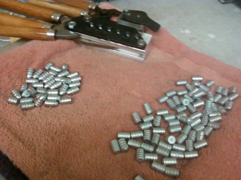 1996 Ford Bronco - Bullet casting equipment and lead projectiles are laid out on a towel, with a SuperMotors watermark visible.
