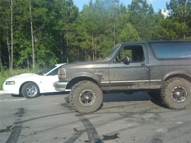 Side view of a lifted 1994 Ford Bronco with large tires