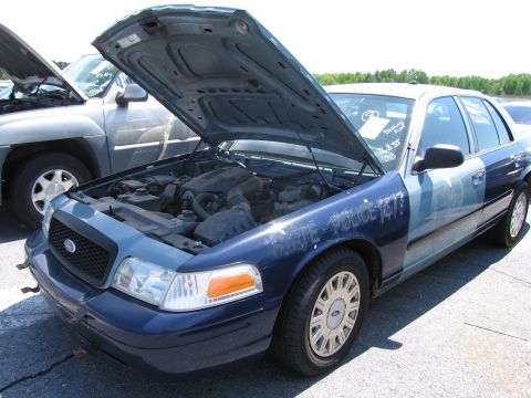 1991 Ford LTD Crown Victoria - This Ford Crown Victoria, possibly a former police vehicle, has its hood open, revealing the engine compartment. Text on the fender indicat…
