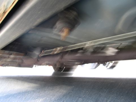 1991 Ford LTD Crown Victoria - The underside of a car shows signs of rust and a visible exhaust system.