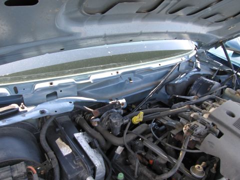 1991 Ford LTD Crown Victoria - Engine bay view under the hood, revealing various mechanical parts and wiring harnesses.