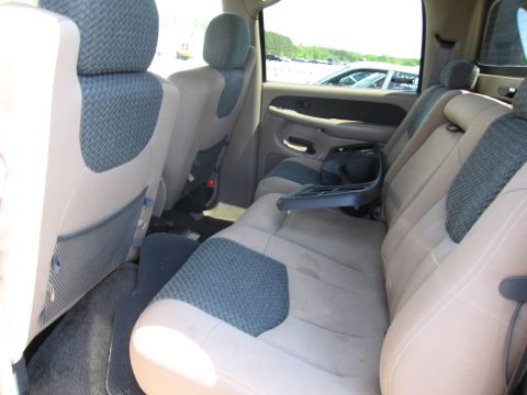 1991 Ford LTD Crown Victoria - Rear interior view of a pickup truck, showing the seats and door panel.