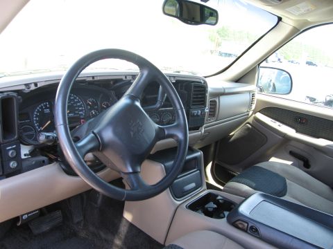 1991 Ford LTD Crown Victoria - The interior of a truck shows the dashboard, steering wheel, and center console with cup holders.